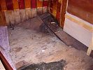 Uncovered original floorboards and corner of the hull in the captain's cabin bedroom